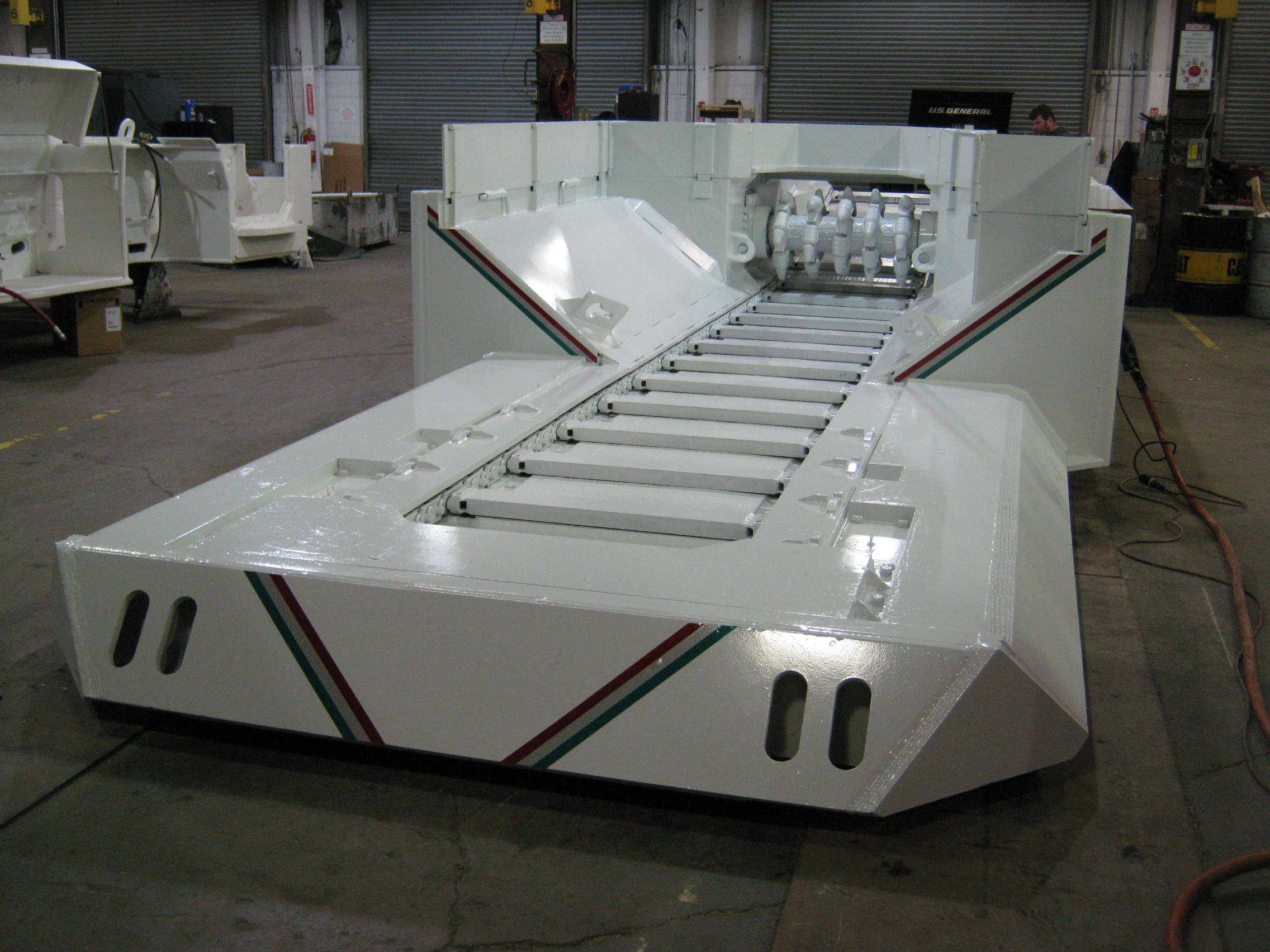 White industrial machinery with a smooth surface and distinct colored stripes